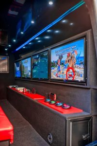 interior of gaming van showing storage cabinets and screens