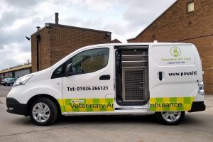 pawsitive vet care vehicle with side door open to reveal dog cage