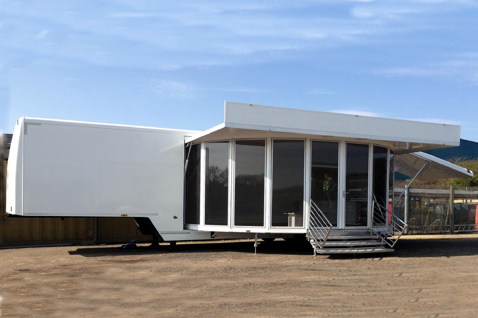 a 10 metre long articulated trailer with a glazed extension with entrance door and entrance steps