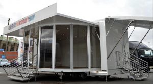 articulated exhibition trailer showing the rear door hinge up canopy and entrance steps