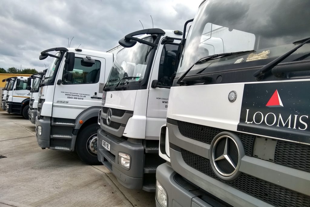 a fleet of cash in transit vehicles parked in a row