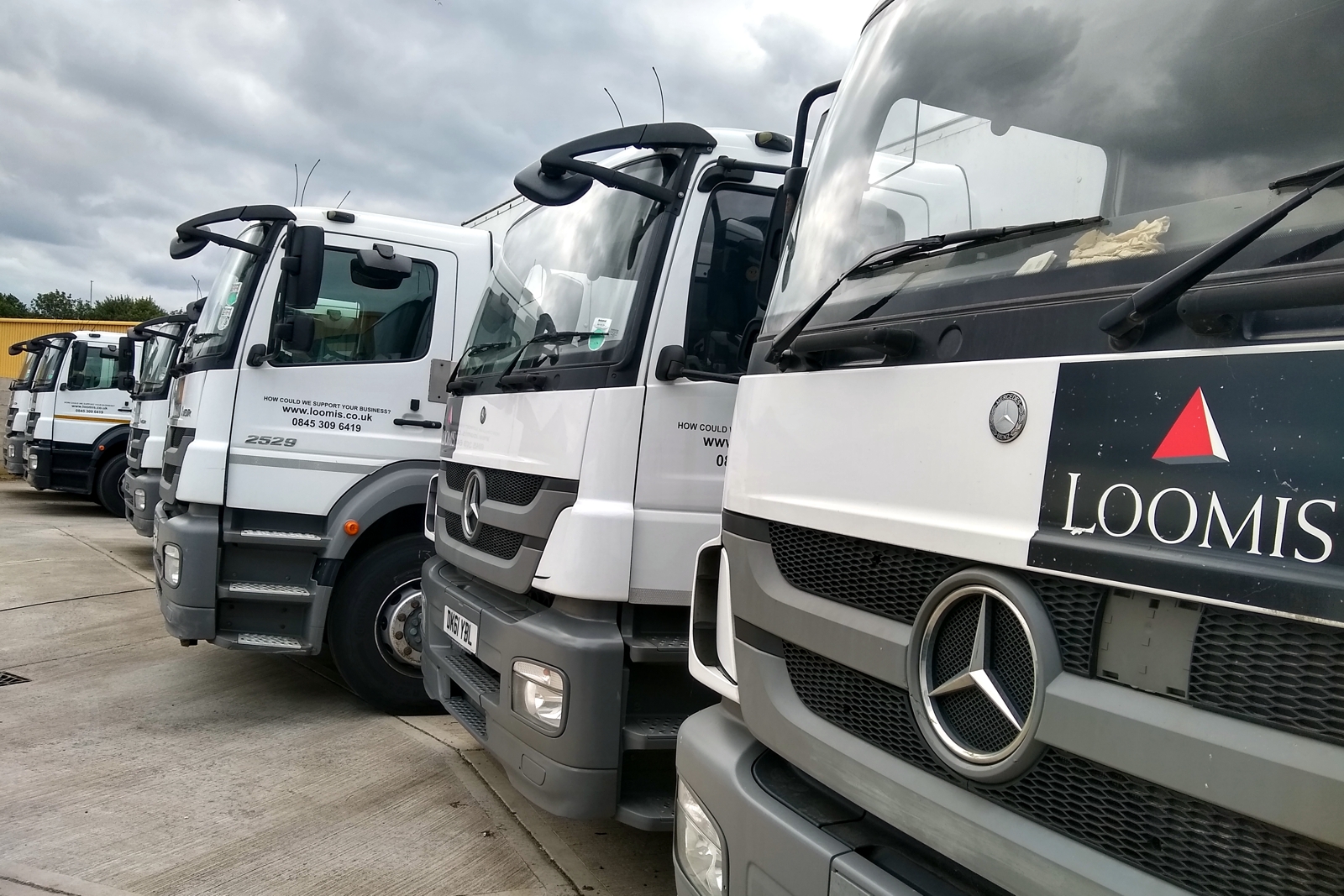a fleet of cash in transit vehicles parked in a row