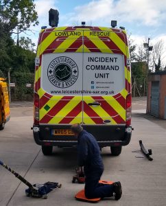 fleet maintenance of a command vehicle with mechanic in foreground