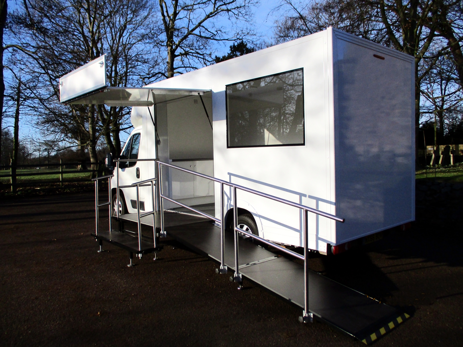 An exhibition vehicle with entrance showing steps and wheelchair ramp
