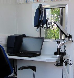 a lap top on a small workstation in a mobile office van