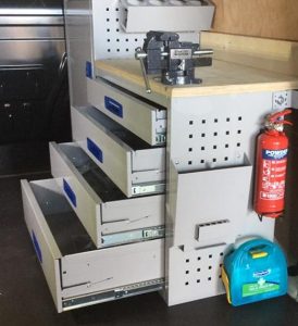 van racking installed as a mobile workshop with worktop and vice