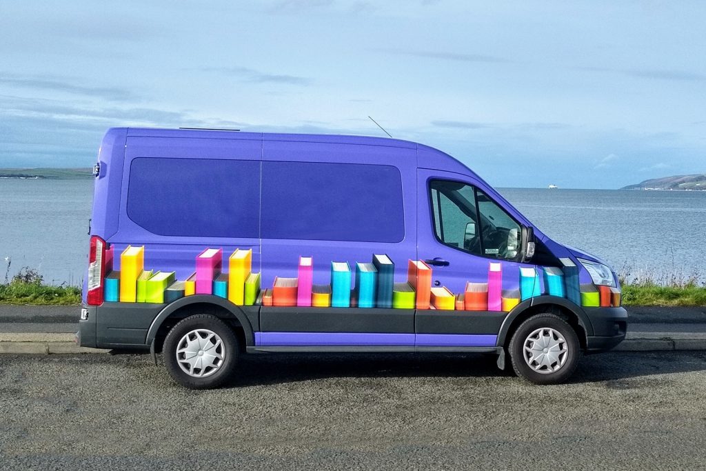 side view of a purple coloured minibus
