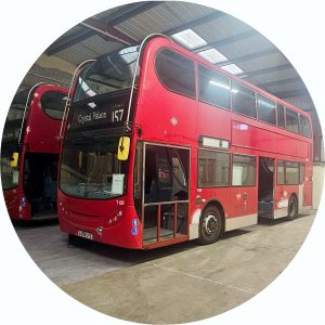 Two red colourded ex Transport for London double deck buses with side doors removed and looking rather sad. They are shown inside of our new factory where work on their transformation into two stunning youth vehicles will soon be under way.