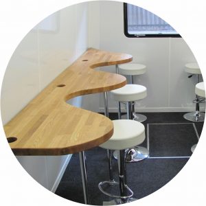 This bus was fitted out with curvy worktops on the upper deck with seating in each curve provided by an attractive stool. This design was created to enable visitors to log on to lap tops provided for training purposes.