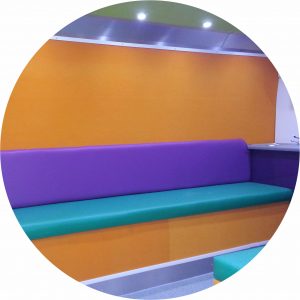 Very colourful bench seating on an upper deck. The use of vibrant colours had been designed for teenagers club meetings