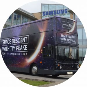 Exterior view from the front offside. All windows are covered with vinyl graphics depicting the universe at night and promoting the Samsung Tim Peake VR Experience Tour