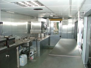 Interior of a customised bus fitted out with catering equipment.