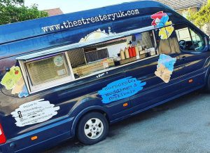 A street food van refurbishment. This shows the exterior of a traditional van with the side panels cut out to createa serving hatch and counter.
