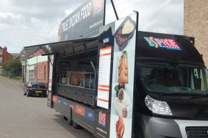 Traditional street food van based on a Fiat Ducato chassis cab with a box body, hinge up canopy and swing out panels serving Indian Food