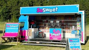 This is a chassis cab based street food vehicle with a difference in that it is selling sweets on a serve your self basis. The side of the vehicle is fully open with an entrance platform and protective hinge up canopy making the interior wide open to the public to walk on.