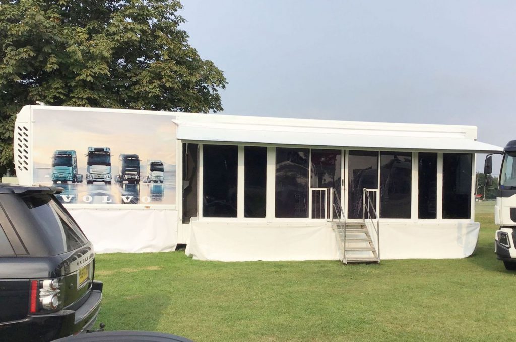 nearside elevation showing an articulated exhibition trailer witha fully glazed extension pod