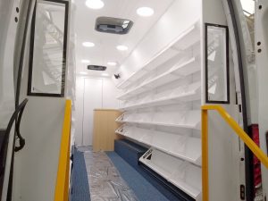 Decorative lining within a mobile library showing white walls and white shelving