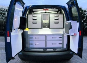 The rear doors of a van open to show a range of drawers built into the interior