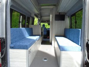 a van conversion made into a camper van with seating in the foreground
