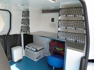 Work desk and storage compartments within animal ambulance