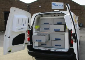 A view into the rear of an animal welfare vehicle showing hand wash unit on rear door and drawers in the main body