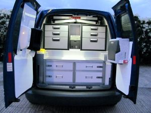 night time photo of the interior of an animal rescue vehicle showing storage drawers and cool box