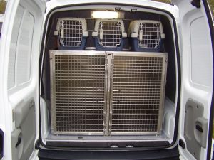 Dog cages and small animal pet carriers secured in the rear of an animal ambulance