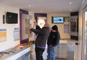 Exhibition vehicle that demonstrated pipe fitting jointing systems. The display is inside of an Iveco daily chassis cab and has two people with one demonstrating a product to the other.