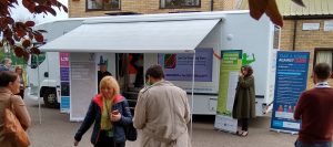 Planning a roadshow is easy for this outreach vehicle. It is a converted mobile library with awning out to provide weather protection. The main body of the vehicle is white with lots of messages on it