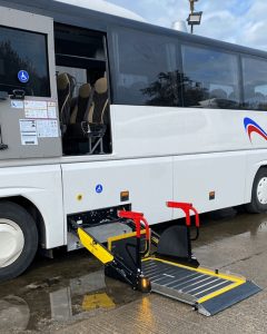 close up view of a pasenger lift fitted to the side of a coach to meke it PSVAR compliant