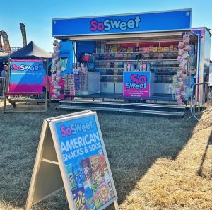 A mobile self service sweet shop with sweet pakets all on display making this a very great successful sales tool an perfect for outdoor exhibition stands