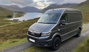 Here we show a plain-looking van in dark metallic colour on an off-road track in the Scottish Highlands. The van is an MAN with off-road capability. This converted van actually contains a full photography studio, along with living accommodation and was built for a lanscape photographer.
