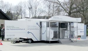 A stunning 7 metre bespoke roadshow trailer designed for public consultation. This trailer is all white and features a glazed entrance gull-wing extension with banner board and swing-out display panels.