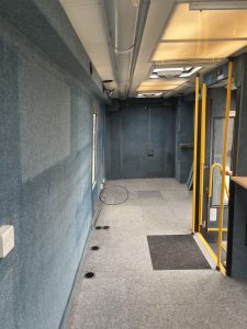 The interior of MVT 94 facing towards the rear with entrance door to the right. The walls are decorated with light blue woollen fabric.