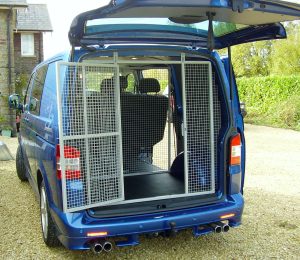 The rear of one of our dog van conversions for business and pleasure, built for a dog agility sports enthusiast. here can be seen the very large cage for a number of dogs fitted within the rear of a large blue van